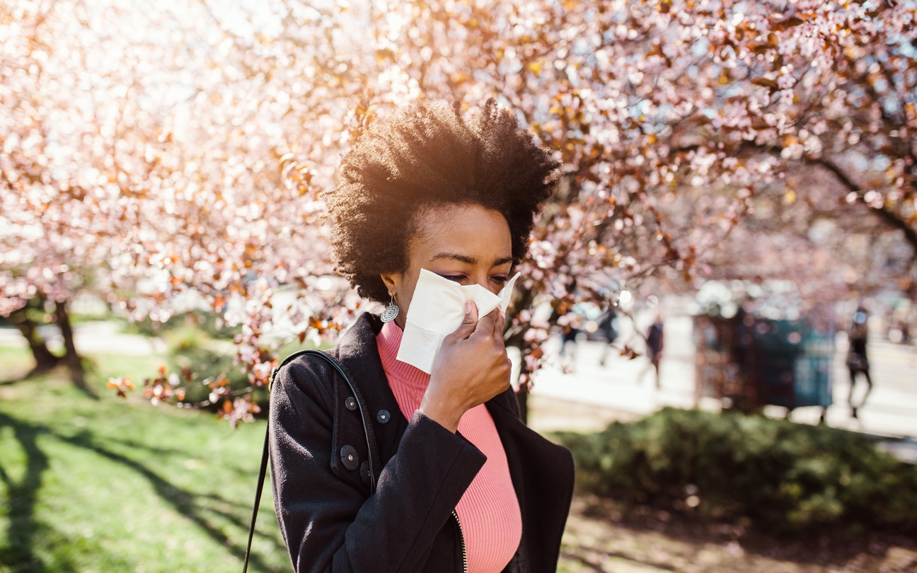 Woman has allergies in park