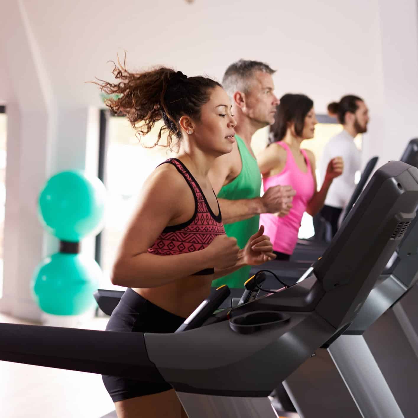 Woman with allergies running on a treadmill in a gym